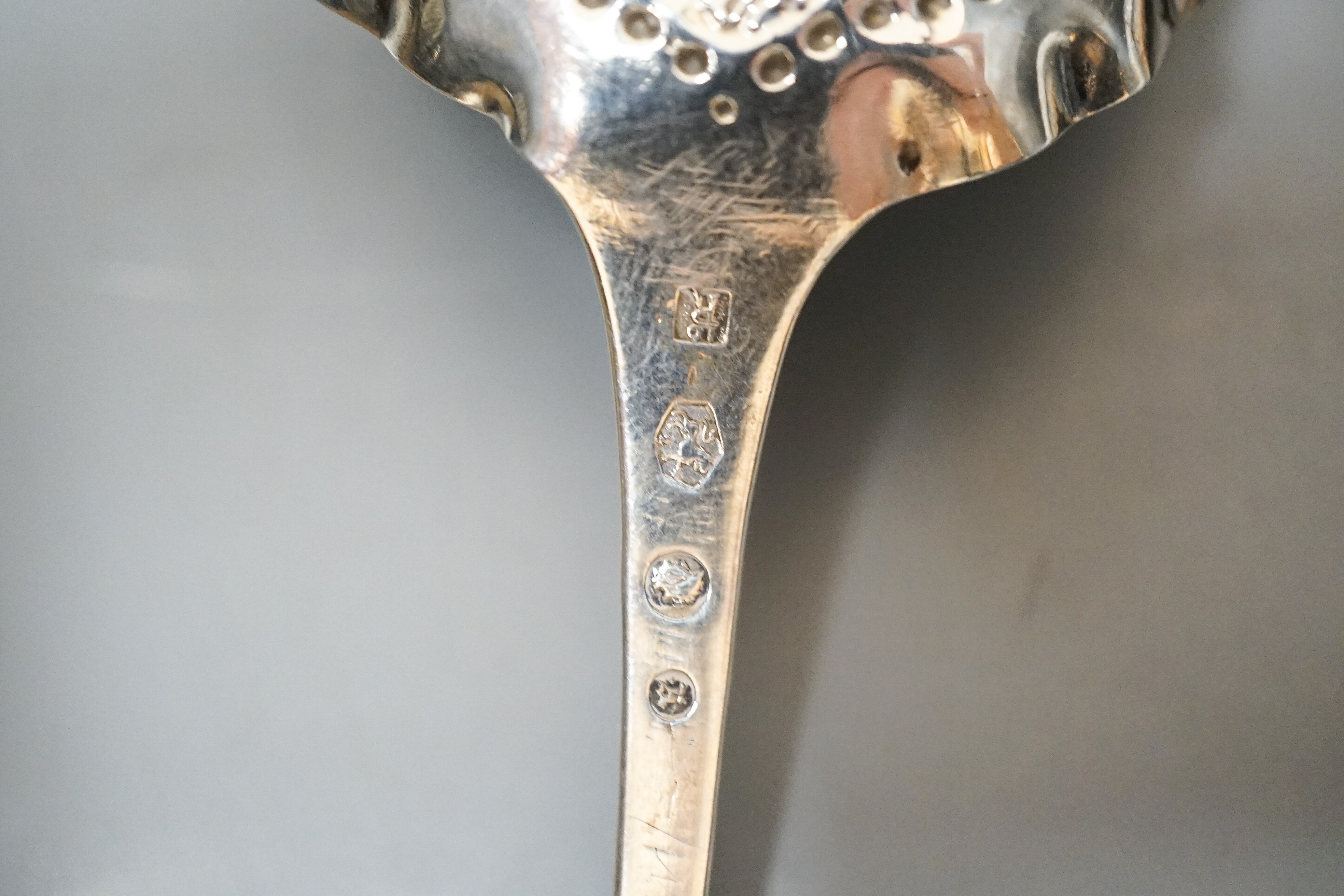 A 19th century Dutch embossed white metal spoon, 13.5cm, one other unmarked white metal spoon, a small silver posy vase and a repousse silver match sleeve.